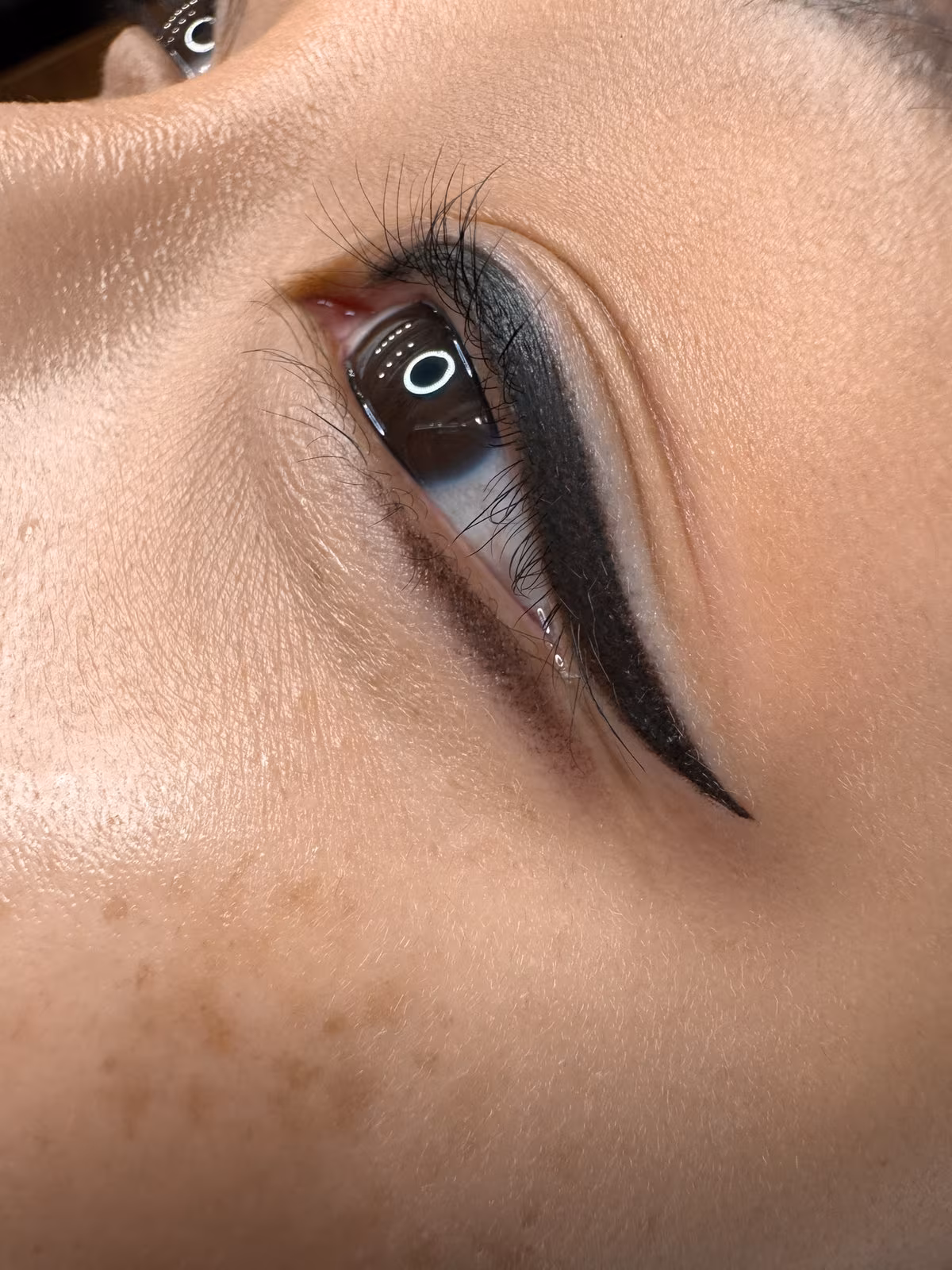 Bold winged eyeliner tattoo with lower eyeliner, permanent eyeliner